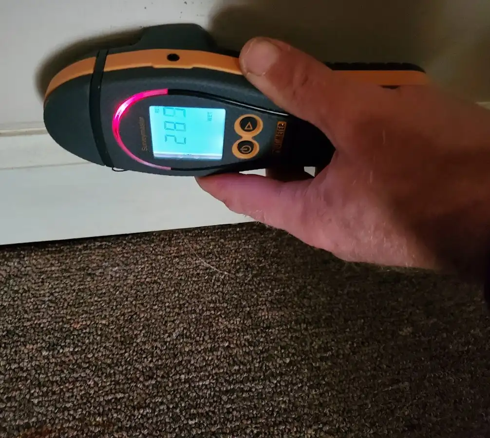 Moisture detection at baseboard during Storm Damage Restoration in Morehead